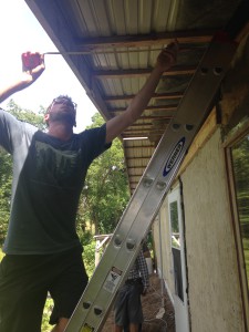 Stephen Whiting measures how wide the soffit will need to be on the north side of the Hab Lab. Photo by Clair Sprenger